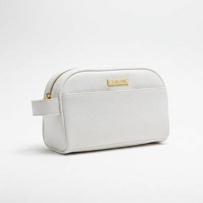 White toiletry bag with a the CLABANE brand logo on a gray surface